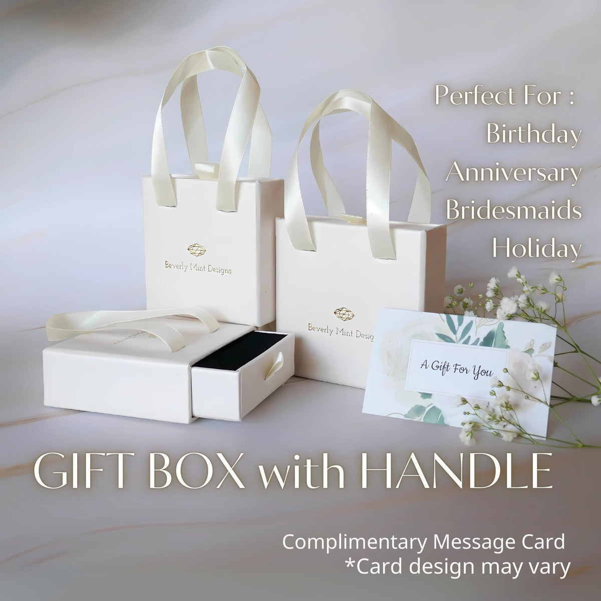 a white gift box with handles and a card