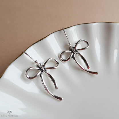 Silver Bow Drop Earrings, Dainty Ribbon Charm, Surgical Steel Hooks, Feminine Minimalist Jewelry, Sensitive Ear & Clip-On Options