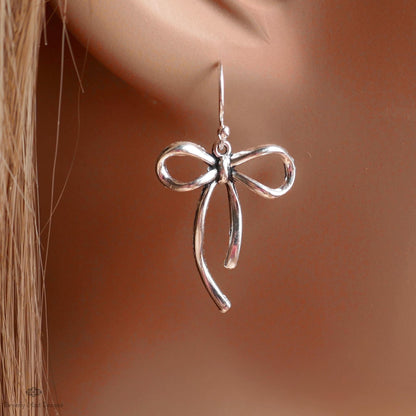 A pair of silver earrings with a bow-shaped design.